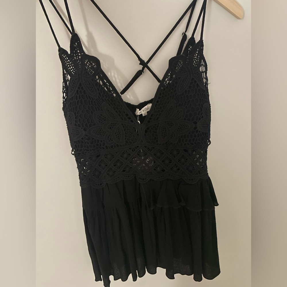 A black lace tank top with adjustable straps. Never worn before.